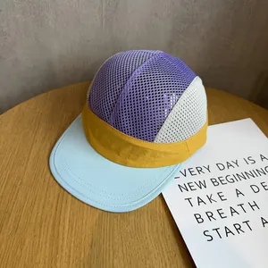 Close-up of a colorful 5-panel mesh flat brim hat with breathable purple and yellow fabrics