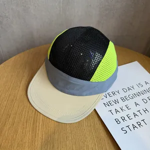 Close-up of five-panel mesh cap showing breathable black and neon yellow textures