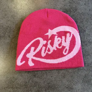 Detailed knit texture of pink Risky letter beanie with street style jacquard pattern