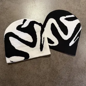 American street style knit beanies featuring abstract black and white wave jacquard patterns
