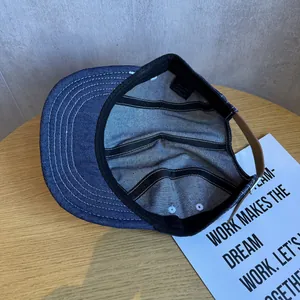 Internal view of a navy blue denim baseball cap featuring premium cotton inner stitching