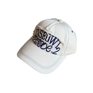 White cotton baseball cap with blue contrast stitching and vintage embroidered patch
