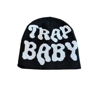 Black knit beanie with TRAP BABY white lettering design for winter street style