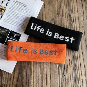 Bandeau de sport élastique en tricot avec lettrage Life is Best en noir et orange