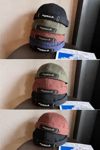 Detail of multi-color brimless docker hats featuring adjustable straps and masicM logo