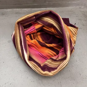 Macro detail of the colorful striped knit pattern on this warm winter infinity scarf