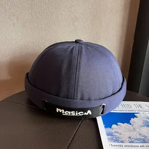 Detail of adjustable nylon strap and white letter embroidery on navy Miki Hat