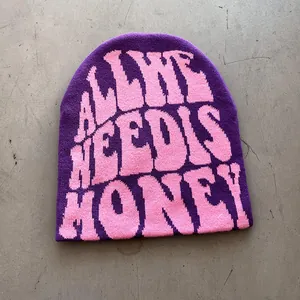 Detail of purple knitted beanie with pink all we need is money text in street style