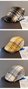 Detailed view of winter wool plaid berets in brown, yellow, and blue checkered patterns
