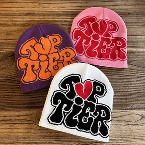 Winter jacquard knit beanies with Top Tier lettering and hearts on wood background
