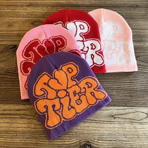 Knitted beanie hats with TOP TIER jacquard lettering in four assorted colors on wood
