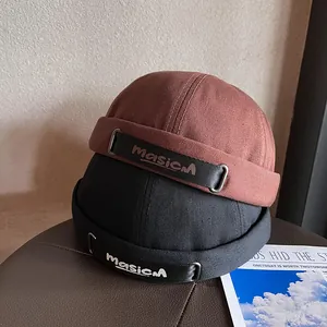 Retro brimless docker hat in brick red and black cotton with masicM logo buckle