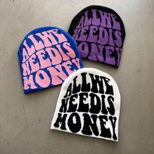 Three trendy knitted beanies with bold jacquard lettering reading All We Need Is Money
