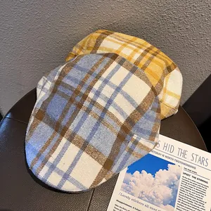 Retro plaid flat cap in blue and yellow knit fabric, stylish unisex beret style accessory