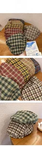 Detail view of retro plaid flat caps in various colors with cotton-polyester texture