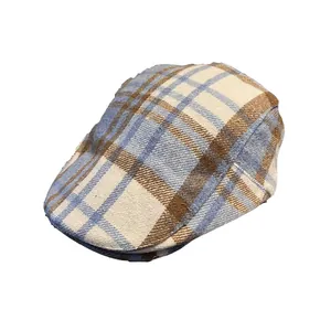 Vintage checkered ivy cap for men and women with blue and brown plaid wool fabric texture