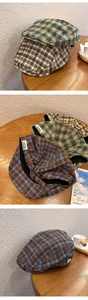 Detailed close-up of retro plaid ivy cap fabric textures and inner brand label
