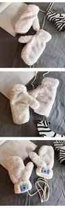 Detailed view of white plush mittens with cute blue koala patch and neck strap cord