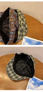 Detail of plaid beret showing metal buckle side strap and internal sweatband lining