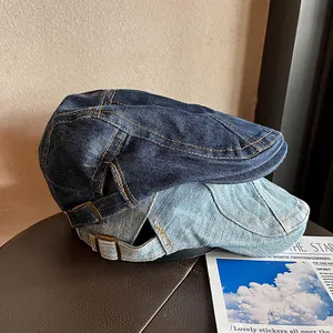 Vintage denim newsboy caps in light and dark blue wash with adjustable metal buckles