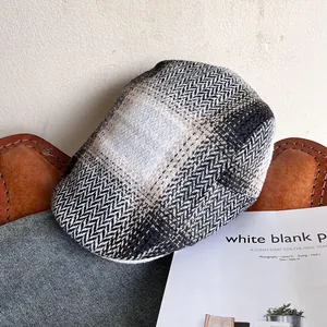 Detail of British herringbone tweed newsboy hat with vintage plaid fabric texture