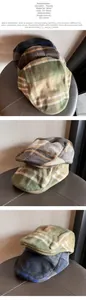 Detail of wool blend plaid newsboy caps showing adjustable size 55-59cm and texture