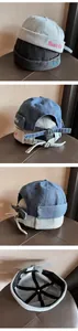 Dettaglio del cappello miki in denim lavato con ricamo Magic Club e fibbia metallica