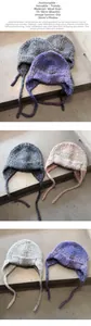 Detailed knit texture of gradient colorful earflap beanie with hanging straps