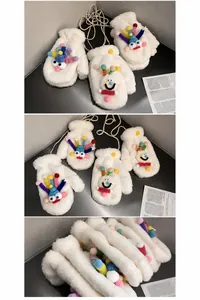 Detail view of thick white plush mittens featuring cartoon faces and neck strap