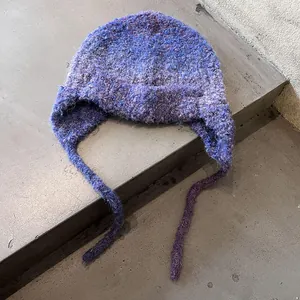 Plush gradient purple knit trapper hat with earflaps and long braided straps