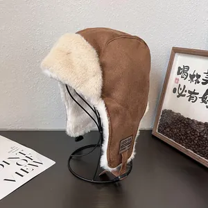 Brown faux suede trapper hat with white faux fur lining and ear flaps for winter