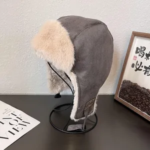 Detail of gray faux suede aviator hat with soft plush lining and UZI side leather patch