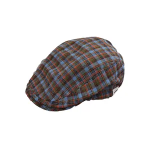 Vintage plaid flat cap with navy and orange check pattern and side brand label