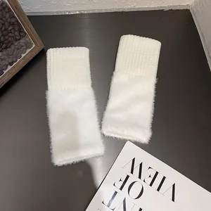 Winter white knit and faux fur wrist warmers for women in a cozy lifestyle setting