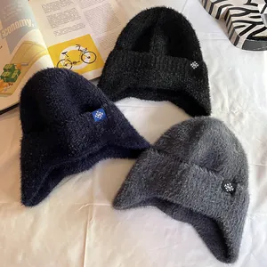 Chunky knit earflap hats for winter in navy, black, and grey with a snowflake patch