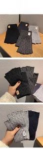 Detail of ribbed knit cuffs and deer leather patch on thermal wool fingerless gloves