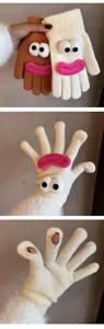 Detail of candy-colored knitted gloves showing eye-mouth design and touchscreen fingertip