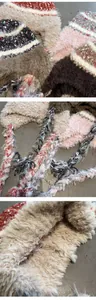 Detail view of colorful faux fur trapper hats with knitted panels and braided tassels