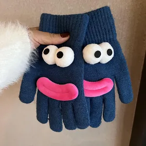 Detail of dark blue knitted gloves with 3D cartoon eyes and pink plush lips decor