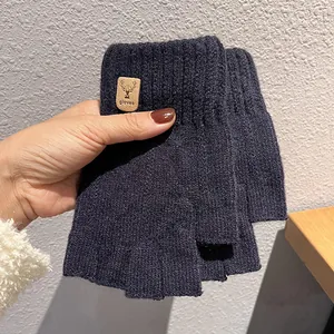 Detail of navy knit fingerless glove with deer leather patch and ribbed wrist cuff