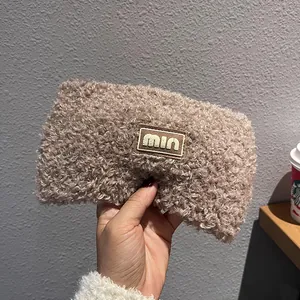 Close-up of brown teddy fleece headband with a stitched rectangular min fabric label