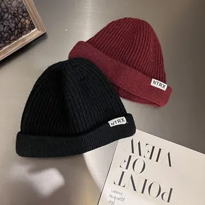 Black and wine red ribbed knit beanie hats with white NTRX label for winter style