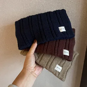 Three colors of ribbed knit headbands in navy blue, reddish brown and oatmeal beige tones