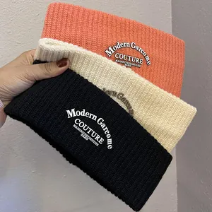 Knitted winter headbands in black, cream, and coral with embroidered couture lettering