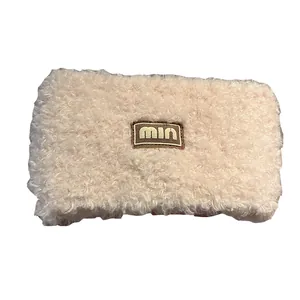Soft cream teddy fleece headband with embroidered logo patch for winter warmth