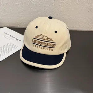 Close-up of retro short brim baseball cap with mountain embroidery and outdoor texture