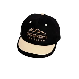 Classic black and cream baseball cap with mountain embroidery and soft brim