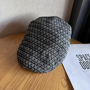 Detailed close-up of textured tweed fabric on a retro newsboy cap against wood background