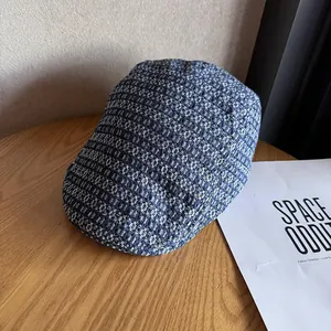 Close-up of blue and white jacquard fabric texture on a retro newsboy cap