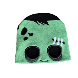 Green knit Frankenstein beanie with cartoon eye cutouts and black hair patterns